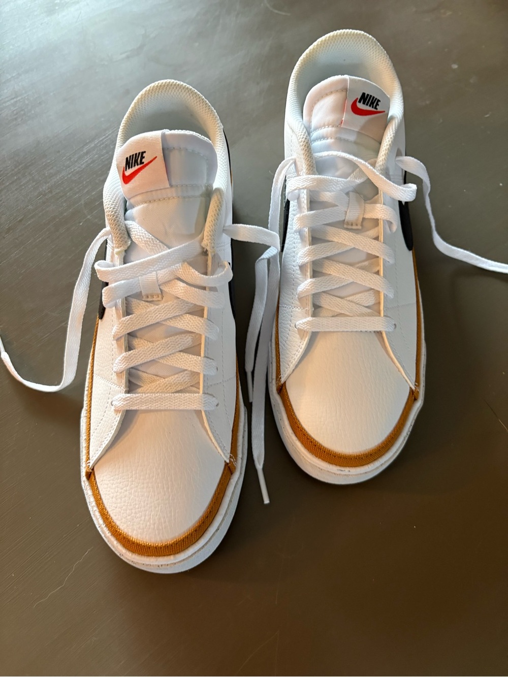 Nike Men’s White Sneakers with Black Swoosh and Gold Trim